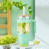 imageTronco 40 oz Glass Tumbler with Handle Bamboo Lid and Straw Fits Cup Holders Reusable Glass Water Bottles for Iced Coffee and Smoothie LeadFree BPAFreeLight GreenBamboo